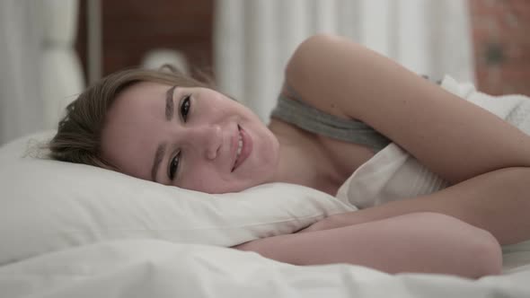 Close Up of Talking Young Woman Chatting in Bed