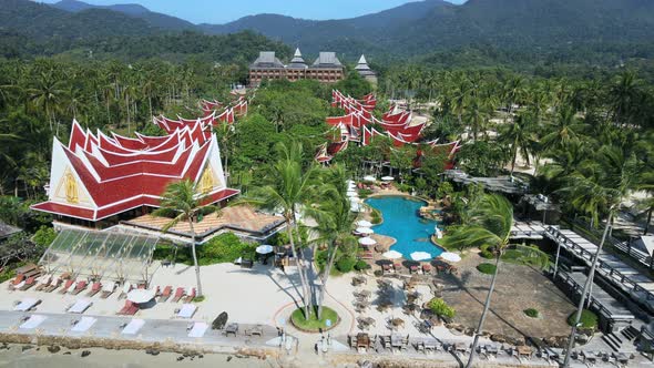 Aerial ascending shot over Beautiful Thailand Resort surrounded by Jungle