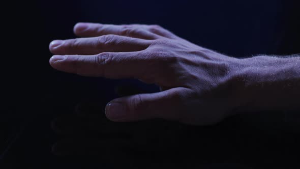 Hand of caucasian man using digital interface placing palm down on touchscreen