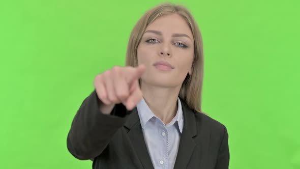 Cheerful Young Businesswoman Pointing Finger Against Chroma Key