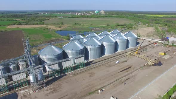 Aerial View Of Big Grain Elevators. Aerial view of grain elevators surrounded by green fields