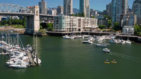 Tourists Riding Waterbike At False Creek With Sailing Boats Near Burrard Bridge IN BC, Canada. - aer