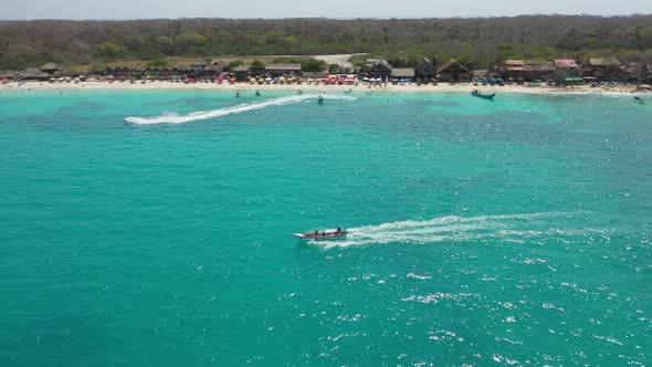 A Pleasure Boat Takes Tourists on an Excursion Along a Sandy Tropical Beach