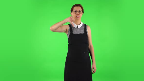 Funny Girl in Round Glasses Is Showing Thumbs Down Gesture, Green Screen