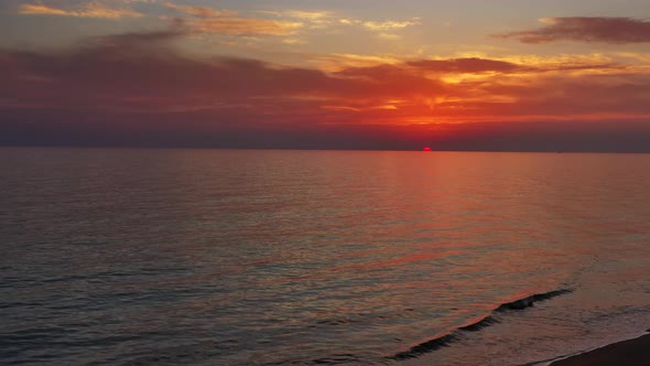 Beach and Calm Sea Surface During Sunset