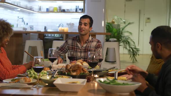 Millennial adult friends celebrating Thanksgiving together at home