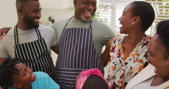 Three generation african american family smiling together in the kitchen at home