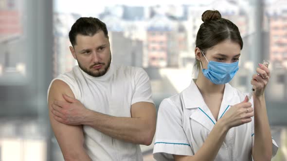 Female Doctor Vaccinating Her Patient From Virus