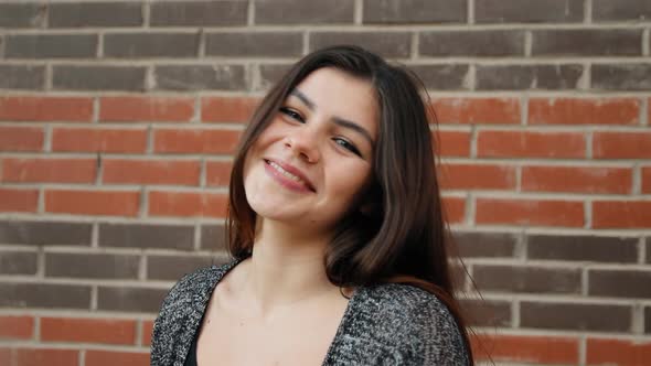  Portrait of a Young Attractive Woman Looks with a Serious Look Then Smiles