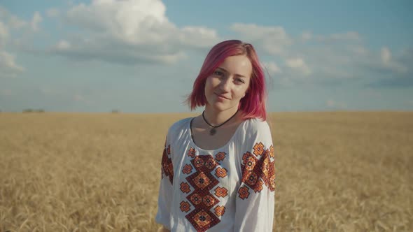 Portrait of Lovely Woman in Wheat Field at Sunset