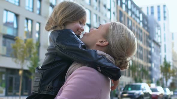 Mother Kissing Daughter Nose Holding Child, Family Love Expression, Tenderness