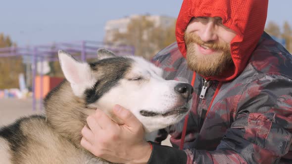 Close-up Man with a Dog Walks By the River, Lake. Favorite Animal, Favorite Pet