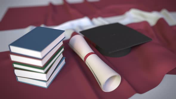 Graduation Cap and Diploma on the Flag of Latvia