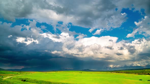 Colorful Clouds Over a Mountain Valley in Spring