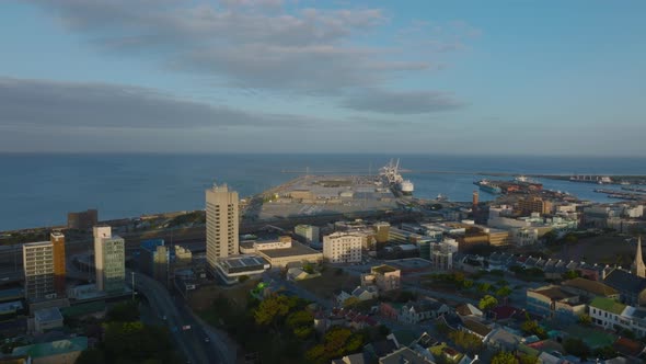 Forwards Fly Above Coastal Town at Golden Hour