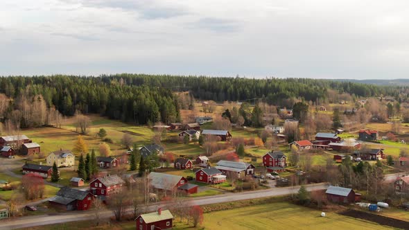 Beautiful Warm Countryside Red Farm Houses And Buildings Near Pine Tree Woodlands in Ostersund, Swed