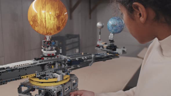 Black Girl Building Solar System Model