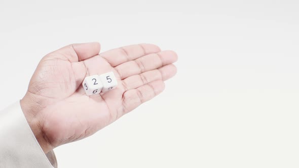 Hand Holds Numbered Dice   Two And Five Twenty Five
