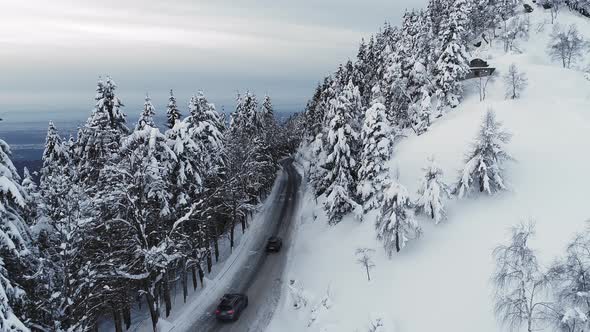 Aerial of Cars Driving in Winter Paradise in Italy
