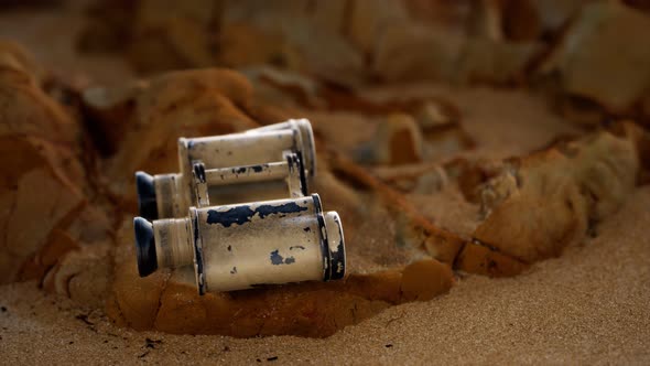 Old German Military Binoculars on the Sand Beach alt