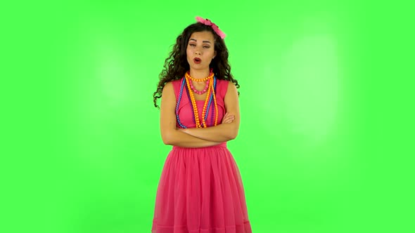 Girl Listens Carefully, Threatens with a Finger and Waves Her Head. Green Screen