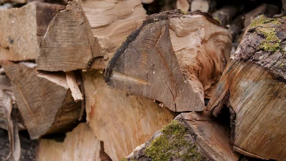 Tight shot of a neatly stacked pile of split wood.