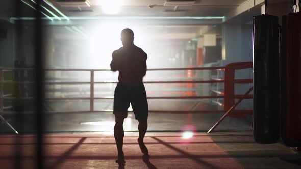 Athletic Man Fighter Trains His Punches Training Day in the Boxing Gym Kickboxing