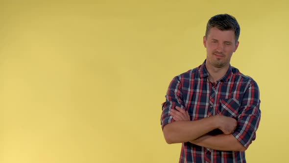 Portrait of Darkhaired Man in Checkered Shirt Showing Negative Feelings and Giving Thumbs Down