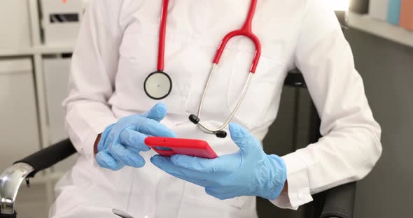 Doctor in Protective Medical Gloves Reading Information From Screen of Mobile Phone  Movie