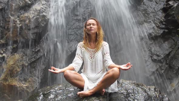 Female Practising Yoga By Waterfall.  Video.