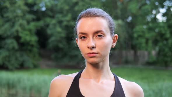 Happy Young Pretty Sporting Girl Turning Her Head Smiling Standing in Park