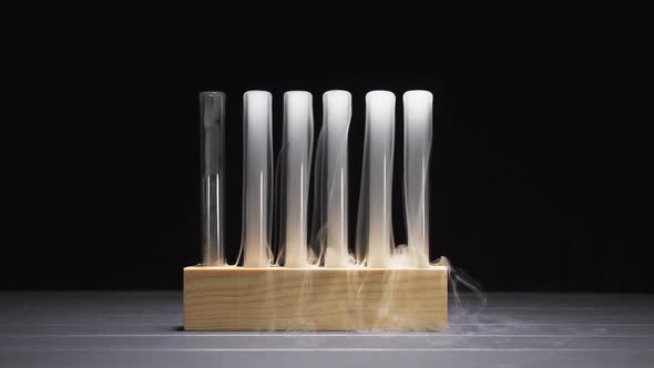 Smoky Glass Test Tubes with Dry Ice on a Black Background
