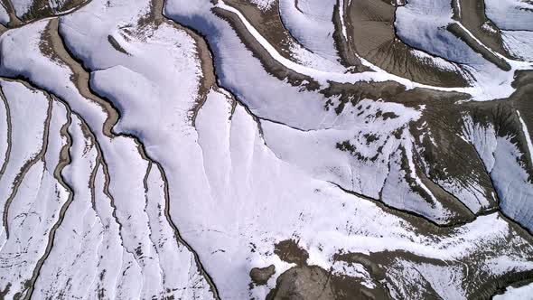 Aerial view looking down at desert eroded terrain in winter