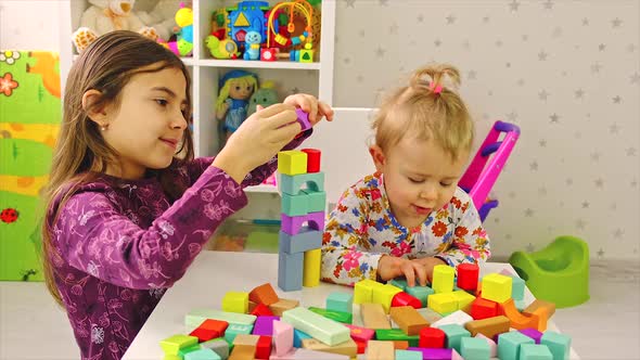 The Child Plays with Toys in the Room