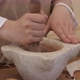 hand with pestle grinds seeds into powder inside the mortar - VideoHive Item for Sale