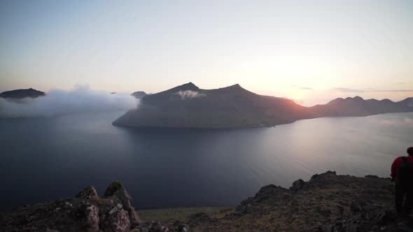 Hiker At Sunrise On Mountainside