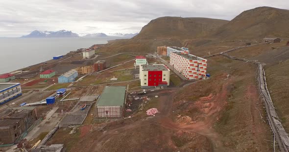 Drone Flight Over the Pipe Stretching By the Ground Along the Settlement of Barentsburg. Spitsbergen