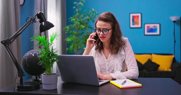 A Young Beautiful Businesswoman Works Remotely From Home