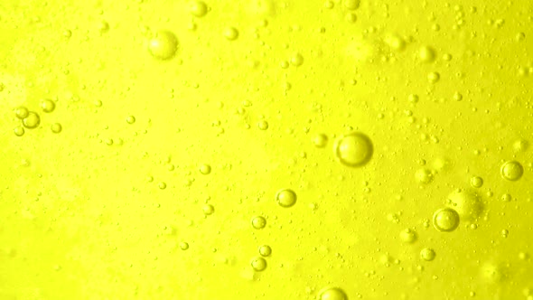 Abstract colorful background. Foam of Soap with Bubbles moving macro shot. Lemon bubbles in water