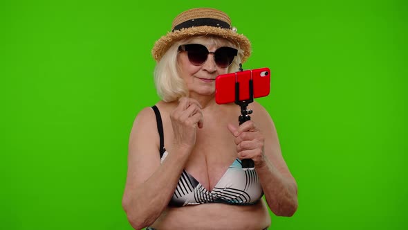 Mature Woman Traveler Blogger in Sunglasses Taking Selfie Portrait Photo Video Call on Smartphone