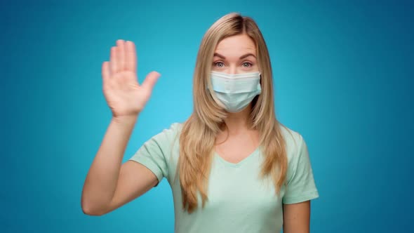 Happy Woman in Medical Mask Shaking Her Hand Greeting Someone Blue Background