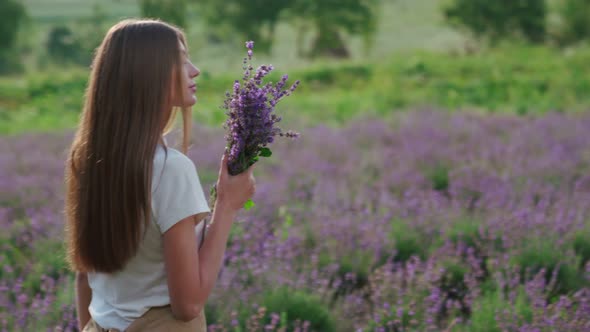 Smiling Woman Posing with Bouquet in Lavender Field