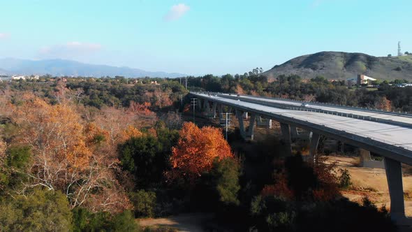 Aerial rising shot over unique bridge traffic.