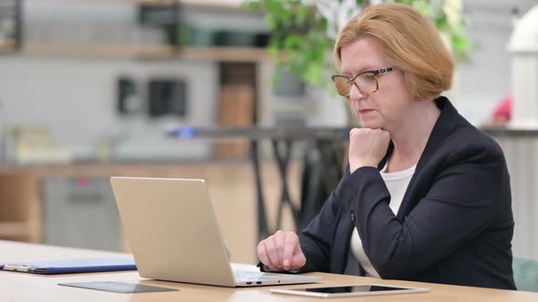 Failure Old Businesswoman Having Loss on Laptop in Office