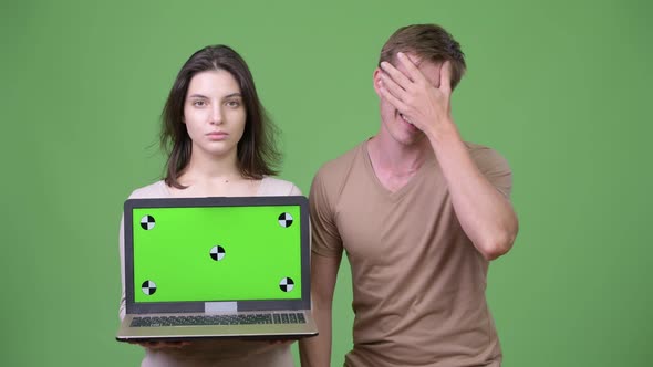 Young Couple Showing Laptop and Getting Bad News Together