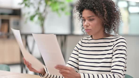 Close Up of Young African Woman Reading Documents