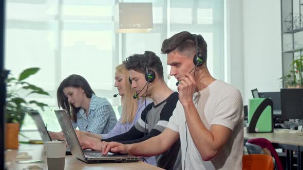 Friendly Young Man Smiling To the Camera, Working at Customer Support Call Center