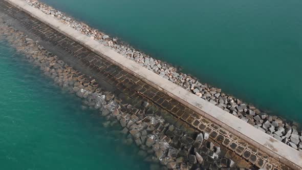 Rocky Pier to Famous Porto de Portimao Lighthouse in Portugal - Aerial