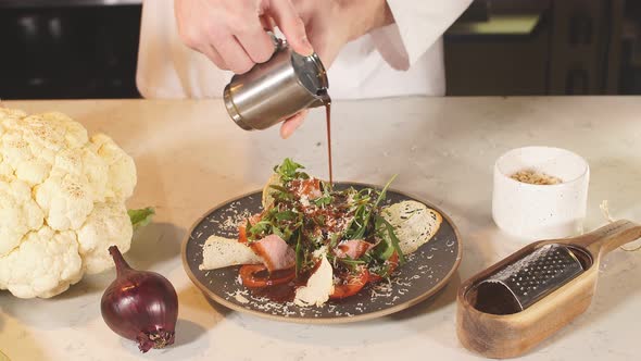 The Chef Pours Sauce Over a Vegetarian Seafood Salad