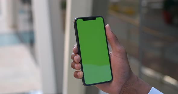 Man Hands Using Smartphone with Mock Up Screen. Close Up View of Afro American Guy Touching and